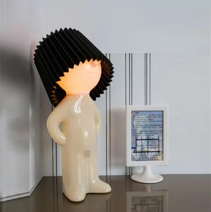 Shy little boy reading lamp